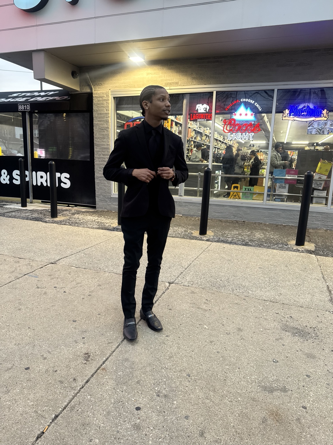 Jarrin in a black suit standing outdoors